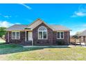 Inviting brick home with a large front window, showcasing classic design and curb appeal at 115 Green Sw St, Concord, NC 28027