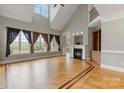 Bright living room with vaulted ceilings, fireplace, and hardwood floors at 116 Whispering Cove Ct, Mooresville, NC 28117