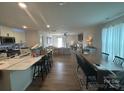Open-concept living space featuring a kitchen with island, dining area, and living room at 120 Parson Ln, Statesville, NC 28625