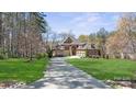 Charming home with well-manicured lawn, beautiful mature trees, and an inviting circular driveway at 1754 Brawley School Rd, Mooresville, NC 28117