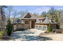 Stunning home boasts meticulous landscaping, a circular driveway, and a three-car garage at 1754 Brawley School Rd, Mooresville, NC 28117
