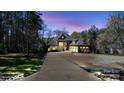 Stately home with a long driveway and 2 car garage surrounded by manicured landscaping at 1754 Brawley School Rd, Mooresville, NC 28117