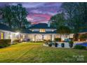 Expansive backyard featuring a large patio, lush green lawn, and outdoor seating areas perfect for entertaining at 200 Highland Forest Dr, Charlotte, NC 28270