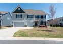 Beautiful two-story home featuring a two-car garage, manicured lawn, and traditional design at 2097 Saddlebred Dr, Iron Station, NC 28080