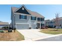 Stylish two-story home with a wide driveway and a well-maintained front lawn at 2097 Saddlebred Dr, Iron Station, NC 28080