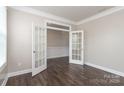 Bright office with dark hardwood floors, glass paneled doors, and white trim at 2097 Saddlebred Dr, Iron Station, NC 28080