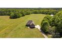 Expansive aerial shot of a secluded home, highlighting its large lot, surrounding greenery, and private driveway at 244 Alexis Lucia Rd, Alexis, NC 28006