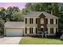Traditional two-story home with black shutters, set against a backdrop of mature trees at 2512 Pimpernel Rd, Charlotte, NC 28213