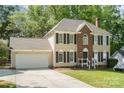 Inviting two-story home with a front-facing garage and a neatly landscaped front yard at 2512 Pimpernel Rd, Charlotte, NC 28213