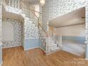 Spacious foyer featuring a staircase leading to the upper level, complemented by patterned wallpaper at 2906 Crescent Knoll Dr, Matthews, NC 28105