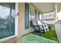 Inviting front porch with rocking chairs and a view of the neighborhood at 2981 Deep Cove Nw Dr, Concord, NC 28027