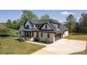 Beautiful two-story home with light brick, black trim, a two car garage and a manicured lawn at 3500 Manna Ln, Mount Holly, NC 28120