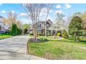 Lovely home with a well-manicured lawn, mature trees, and a long driveway leading to the garage at 4715 Amberside Dr, Rock Hill, SC 29732