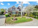 Attractive two-story home boasting a lush lawn, mature landscaping, and a welcoming facade at 4715 Amberside Dr, Rock Hill, SC 29732