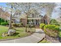 Charming two-story brick home featuring a beautifully landscaped front yard and inviting walkway at 4715 Amberside Dr, Rock Hill, SC 29732
