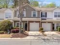 Charming two-story townhome with a well-manicured lawn and an attached one-car garage at 475 Delta Dr, Fort Mill, SC 29715