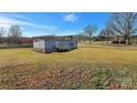 Spacious yard surrounds a cozy single-story home with a charming back porch at 501 Mt. Wesley Church Rd, Hiddenite, NC 28636