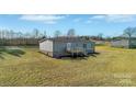 The home's back exterior shows a deck and manicured landscaping at 525 Mt. Wesley Church Rd, Hiddenite, NC 28636
