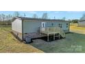 Back exterior showing the deck, new landscaping and the HVAC at 525 Mt. Wesley Church Rd, Hiddenite, NC 28636