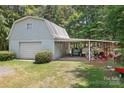 A detached garage and covered area offering ample storage and parking, surrounded by greenery and a well-kept lawn at 6575 Charlotte Hwy, York, SC 29745
