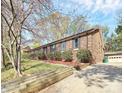 Beautiful brick home exterior with well-maintained landscaping and a detached garage at 7034 Leaves Ln, Charlotte, NC 28213