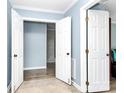 Open foyer with neutral paint, white doors, decorative tile flooring and hardwood flooring at 7034 Leaves Ln, Charlotte, NC 28213