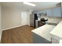 Well-lit kitchen with stainless steel appliances and blue cabinets at 7147 Henderson Valley Ln, Charlotte, NC 28269