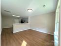 Bright and airy living room showcasing sleek wood floors and neutral walls at 7147 Henderson Valley Ln, Charlotte, NC 28269