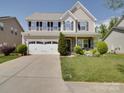 Traditional two-story house with a front-facing two car garage and an extended driveway at 848 Wingthorn Rose Dr, Gastonia, NC 28056