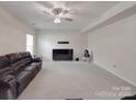 Expansive living area with plush carpeting, a ceiling fan, and natural light at 848 Wingthorn Rose Dr, Gastonia, NC 28056
