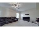 Spacious carpeted living room with ceiling fan, media connections and comfortable seating at 848 Wingthorn Rose Dr, Gastonia, NC 28056