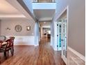 Elegant foyer with wood floors, soaring ceilings, and an open floor plan, creating a grand entrance at 9622 Harvest Pond Nw Dr, Concord, NC 28027