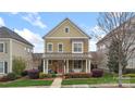 Inviting two-story home with a cozy front porch and beautifully landscaped yard at 1117 Cedar Park Dr, Pineville, NC 28134