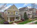 Charming two-story home with a welcoming front porch and manicured front yard at 1117 Cedar Park Dr, Pineville, NC 28134