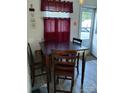 Cozy dining area features a wooden table, chairs, and ample natural light from the adjacent door and window at 1204 Borders Rd, Shelby, NC 28150