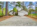 View of a spacious driveway and garage with a well-maintained yard at 1212 Robinhood Cir, Charlotte, NC 28227