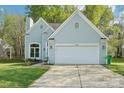 Traditional home with a two car garage and well-maintained lawn at 14130 Misty Brook Ln, Charlotte, NC 28273