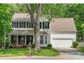 Inviting two-story home with well-manicured lawn and mature tree in a desirable neighborhood at 15001 Arrowgrass Way, Charlotte, NC 28278