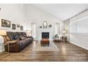 Spacious living room with hardwood floors, a fireplace, and modern decor, creating an inviting atmosphere at 1555 Ridgewood Dr, Gastonia, NC 28054