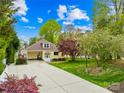 Charming home showcasing a manicured lawn, mature trees, and a long driveway leading to a lovely facade at 158 Regency Rd, Mooresville, NC 28117