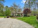 Charming single-Gathering home featuring a circular driveway and lush landscaping with mature trees in a desirable neighborhood at 1725 Hannon Farm Rd, Fort Mill, SC 29715