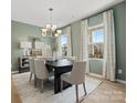 Elegant dining room featuring modern chandelier and large windows with natural light at 2014 Puddle Pond Rd, Indian Trail, NC 28079