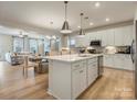 Open-concept kitchen featuring a large island, stainless appliances, and ample counter space at 2014 Puddle Pond Rd, Indian Trail, NC 28079
