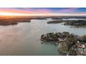 Expansive aerial view of a lakeside property with multiple docks and lush green surroundings at 239 Paradise Peninsula Rd, Mooresville, NC 28117