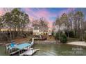 Stunning waterfront home with a private dock, lush landscaping, and a serene lakeside setting at 239 Paradise Peninsula Rd, Mooresville, NC 28117