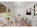 Cozy breakfast nook with a round table, seating for four, and sliding glass doors to the outdoor patio at 303 Windy Rush Rd, Kannapolis, NC 28081