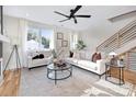 Bright living room with neutral tones, large windows, sleek furnishings, and a modern staircase at 3129 Rush Ave, Charlotte, NC 28208