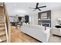 Open-concept living area with a modern fireplace, hardwood floors, and a glimpse of the kitchen at 3129 Rush Ave, Charlotte, NC 28208