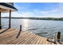 Lakeside view from a wooden dock with blue sky, calm water, and distant trees at 338 Fairfield Ct, Mount Gilead, NC 27306