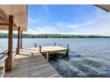 Scenic lake view from a weathered wooden dock, showcasing tranquil water and distant shoreline at 338 Fairfield Ct, Mount Gilead, NC 27306
